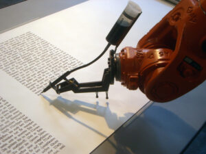 Robot arm writing with pen.
